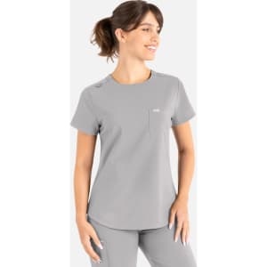 A grey round neck top with a pocket and shoulder detail, designed as a uniform scrub top.