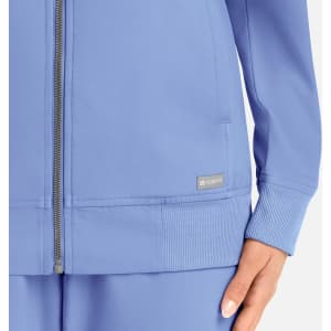 A full zip bomber jacket in light blue, featuring a branded logo and ribbed cuffs.