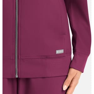 A women's full zip bomber jacket in a rich plum colour, featuring a zip closure and ribbed cuffs, with a logo.