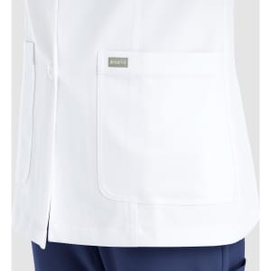A white women's lab coat featuring a pocket, with a logo on the side. The coat has a sleek, professional design.