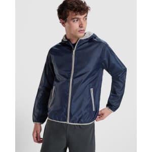 A navy windbreaker jacket with a grey hood, featuring zippered pockets and a front zipper, with a logo.