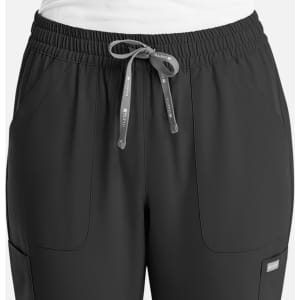 A pair of women's full elastic pull-on pants in dark grey with a drawstring and pockets, featuring a logo.