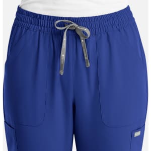 A pair of women's pull-on pants in vibrant blue with an elastic waistband and side pockets. Features a branding logo.