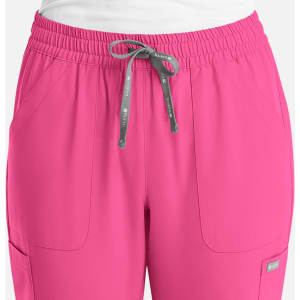 A pair of women's full elastic pull-on pants in bright pink featuring side pockets and a drawstring.