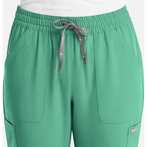 A pair of women's full elastic pull-on pants in green with an adjustable drawstring and side pockets.