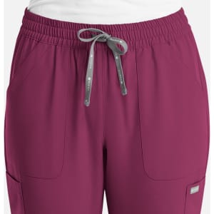 A pair of women's full elastic pull-on pants in a rich burgundy colour, featuring pockets and a drawstring.