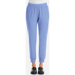 A pair of women's jogger pants in light blue with a comfortable waistband and a side pocket, featuring a logo.