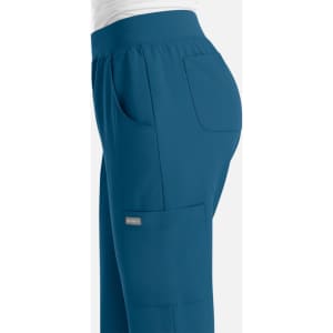 A pair of women's joggers in teal, featuring pockets and a comfortable elastic waistband. It has a small logo.