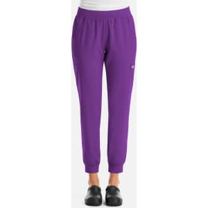 A pair of women's joggers in vibrant purple with an elastic waistband and pockets, featuring a small logo.