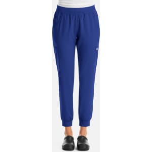 A pair of women's joggers in a vibrant blue colour, featuring a logo and side pockets.