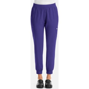A pair of women's joggers in vibrant purple, featuring an elastic waistband and pockets. The joggers have a logo.