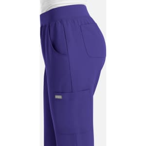 A women's jogger pant in deep purple with side pockets and a comfortable waistband, featuring a small logo.