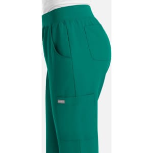 Green women's yoga waist jogger featuring side pockets and an elastic waistband, with a logo on the fabric.