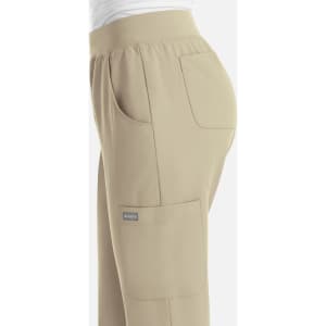A pair of women's jogger pants in a tan colour, featuring side pockets and an elastic waistband.