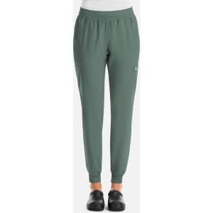A pair of women's joggers in a green colour with an elastic waistband and side pockets. Features a logo on the leg.