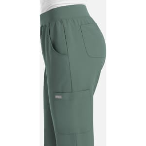 A pair of women's jogger pants in a muted green colour, featuring side pockets and an elastic waistband.