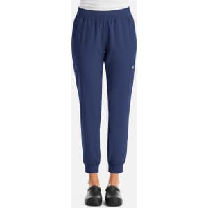 A pair of navy blue women's joggers with an elastic waistband and a pocket, featuring a logo.