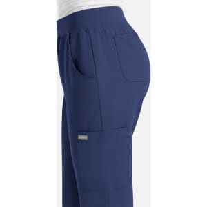 A pair of navy women's jogger-style pants with pockets and a fitted waist, featuring a logo.