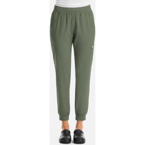 A pair of women's joggers in olive green with an elastic waistband and side pockets. Features a logo on the leg.