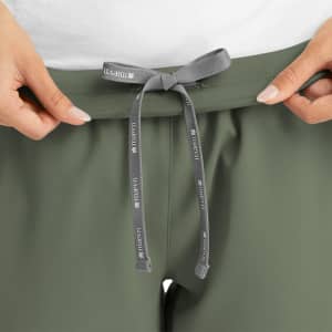 A pair of women's yoga joggers in olive green, featuring a grey drawstring at the waist and a logo.