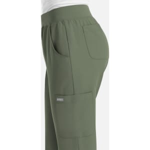 A pair of women's joggers in olive green, featuring pockets and an elastic waistband. The design includes a logo.