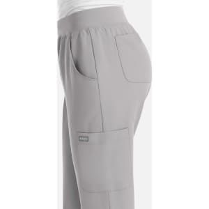 A pair of light grey women's joggers with pockets and an elastic waistband, featuring a branded logo.