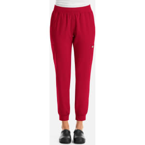 A pair of women's joggers in vibrant red with an elasticated waist and cuffs, featuring side pockets and a logo.