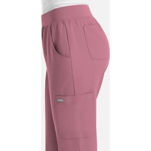 A pair of pink women's joggers featuring side pockets and an elastic waistband, with a small logo.