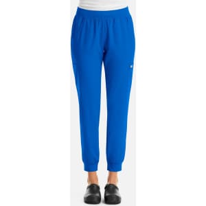 A pair of blue women's jogger pants with an elastic waistband and tapered cuffs, featuring a small logo.