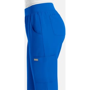 A pair of women's joggers in vibrant blue, featuring pockets and an elastic waistband, with a logo visible.