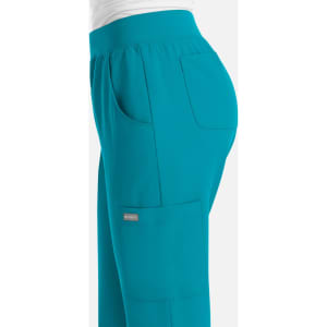 A pair of women's jogger pants in teal, featuring side pockets and an elastic waistband.