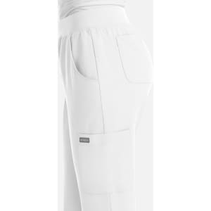 A white women's yoga jogger featuring side pockets and an elastic waistband, with a branding logo.