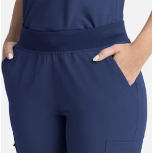 A pair of navy blue women's flare leg pants featuring a full elastic band and side pockets.