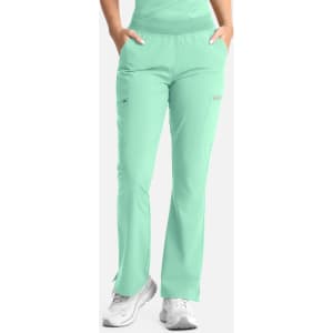 A pair of women's flare leg pants in a mint green colour with an elastic waistband and side pocket.