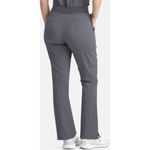 A pair of women's flare leg pants in grey with a full elastic band and pockets, worn with white shoes.