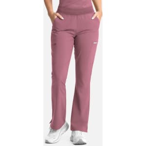 A pair of women's flare leg pants in a mauve colour with an elastic band and side pockets, featuring a logo.