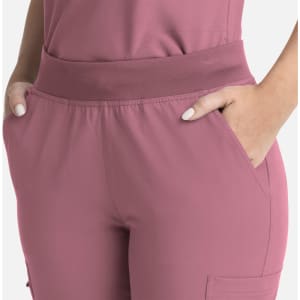 A close-up of women's flare leg pants in a soft pink hue, featuring a full elastic band and side pockets.