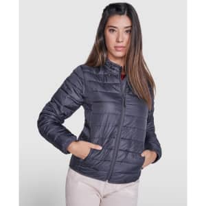 A waterproof women’s jacket in dark grey, featuring a zip front and side pockets. The model wears it stylishly.