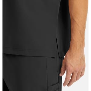 A close-up of a men's tuckable v-neck top in black, featuring a side slit and part of a hand. There is a logo visible.