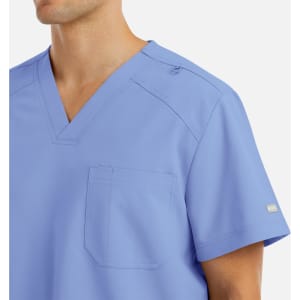 A men's tuckable v-neck top in light blue, featuring a pocket and a logo on the sleeve.