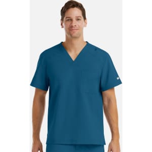 A men's tuckable v-neck top in teal blue with a chest pocket and a logo on the sleeve.
