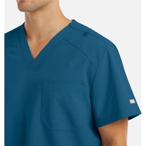 A men's v-neck top in a vibrant blue colour, featuring a pocket and a logo on the sleeve.
