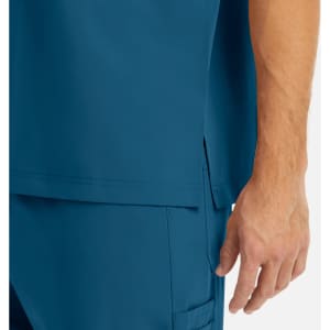 A close-up of a men's tuckable v-neck top in a deep blue colour, featuring a side slit design.