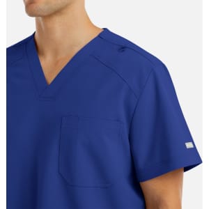 A men's v-neck top in royal blue with a pocket and branding on the sleeve.