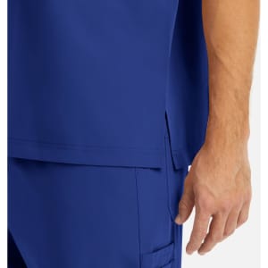 A close-up of a men's tuckable V-neck top in blue, featuring a side slit and visible stitching details.