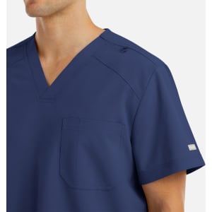 A navy blue V-neck top with a pocket, featuring a logo on the sleeve and shoulder snaps.