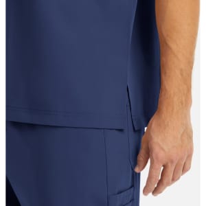 A navy men's tuckable V-neck top featuring a side slit and a hand resting near the bottom hem.
