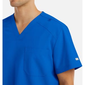 A men's v-neck top in a vibrant royal blue, featuring a chest pocket and branding on the sleeve.