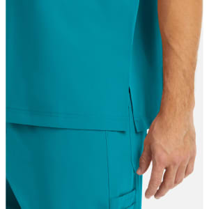 A close-up of a turquoise men's tuckable V-neck top, showcasing the fabric and cut details.