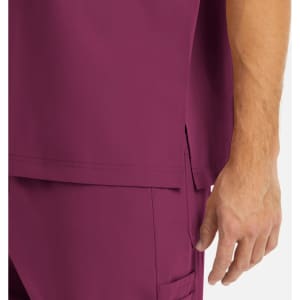 A maroon tuckable V-neck top featuring side slits, showing part of the sleeve and a hand.